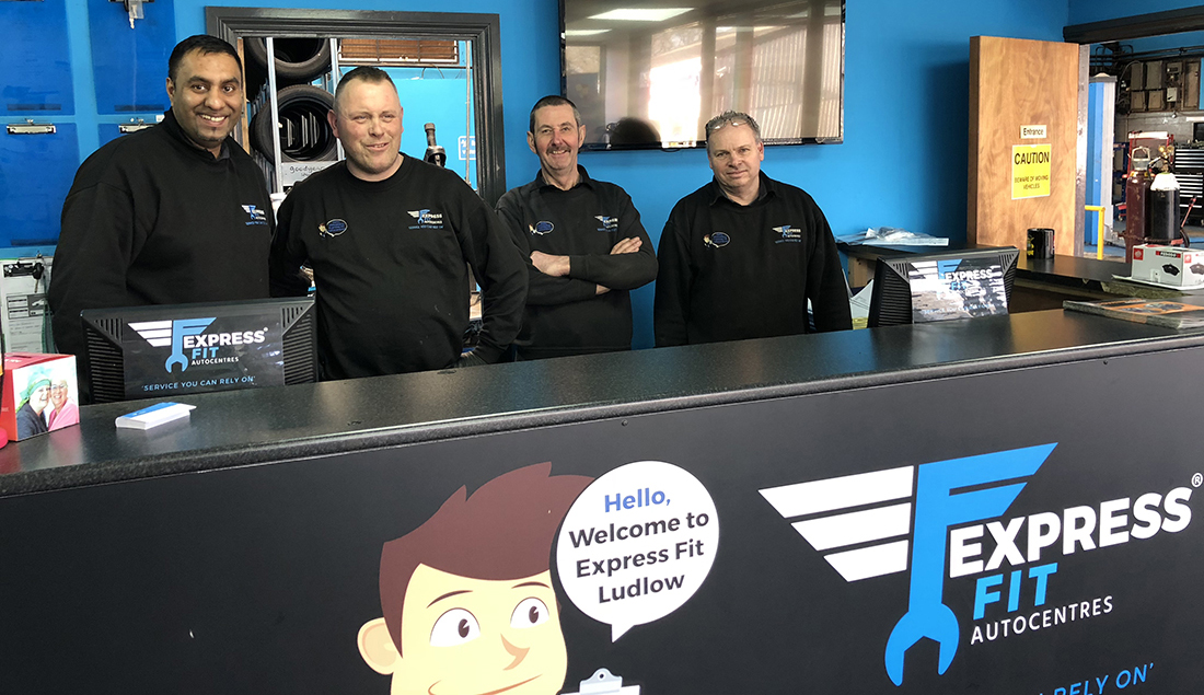 Our team of mechanics behind reception desk