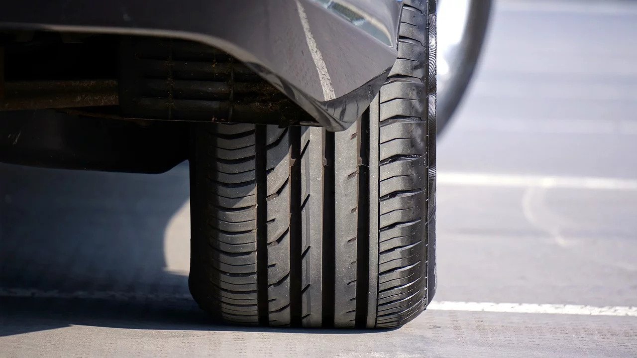 Close up of car tyre driving on road
